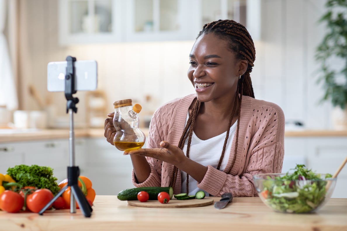 Nutrition Coach. Smiling Black Lady Recording Video Recipe In Kitchen